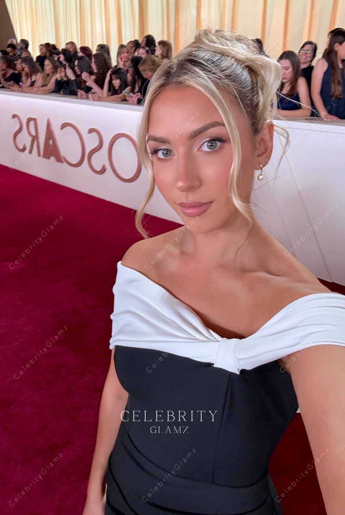 Katie Feeney 2025 Oscars red carpet asymmetrical neckline dress