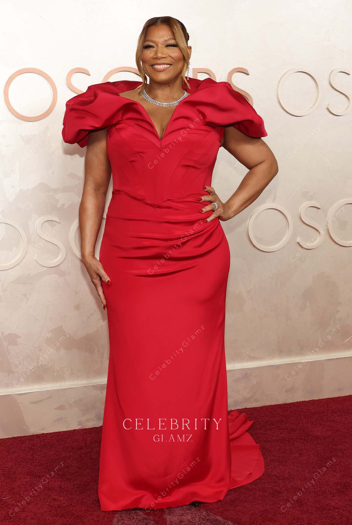 Queen Latifah red 2025 Oscars red carpet fit flare dress
