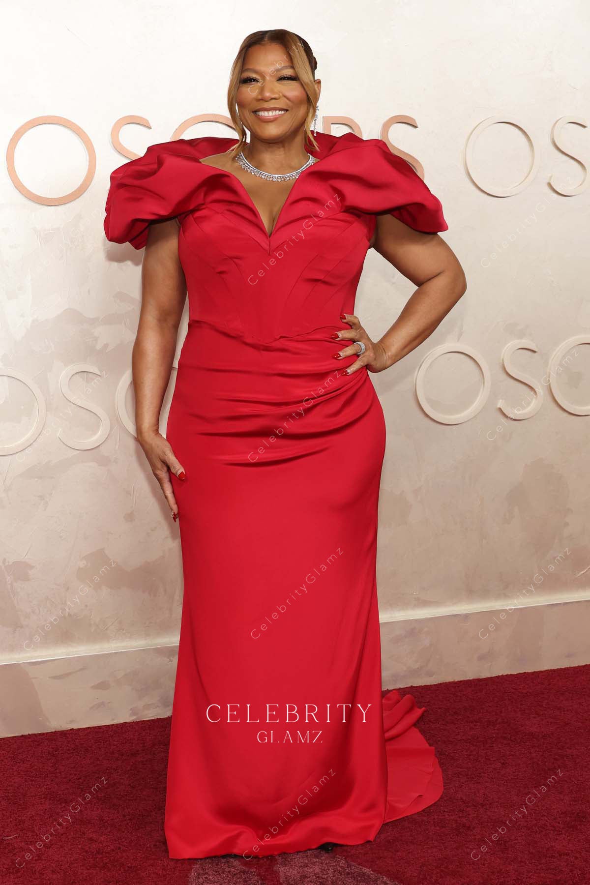Queen Latifah red 2025 Oscars red carpet fit flare dress