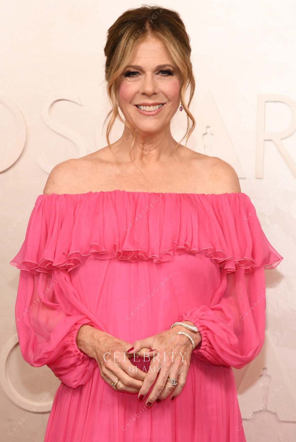 Rita Wilson 2025 Oscars red carpet ruffled neckline dress