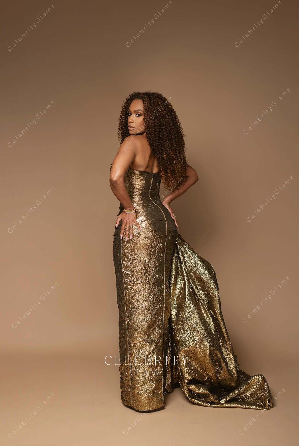 Ryan Michelle Bathe metallic gold 2025 Oscars red carpet floor length dress