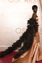 Anok Yai feathers streamer 2025 Oscars red carpet dress 