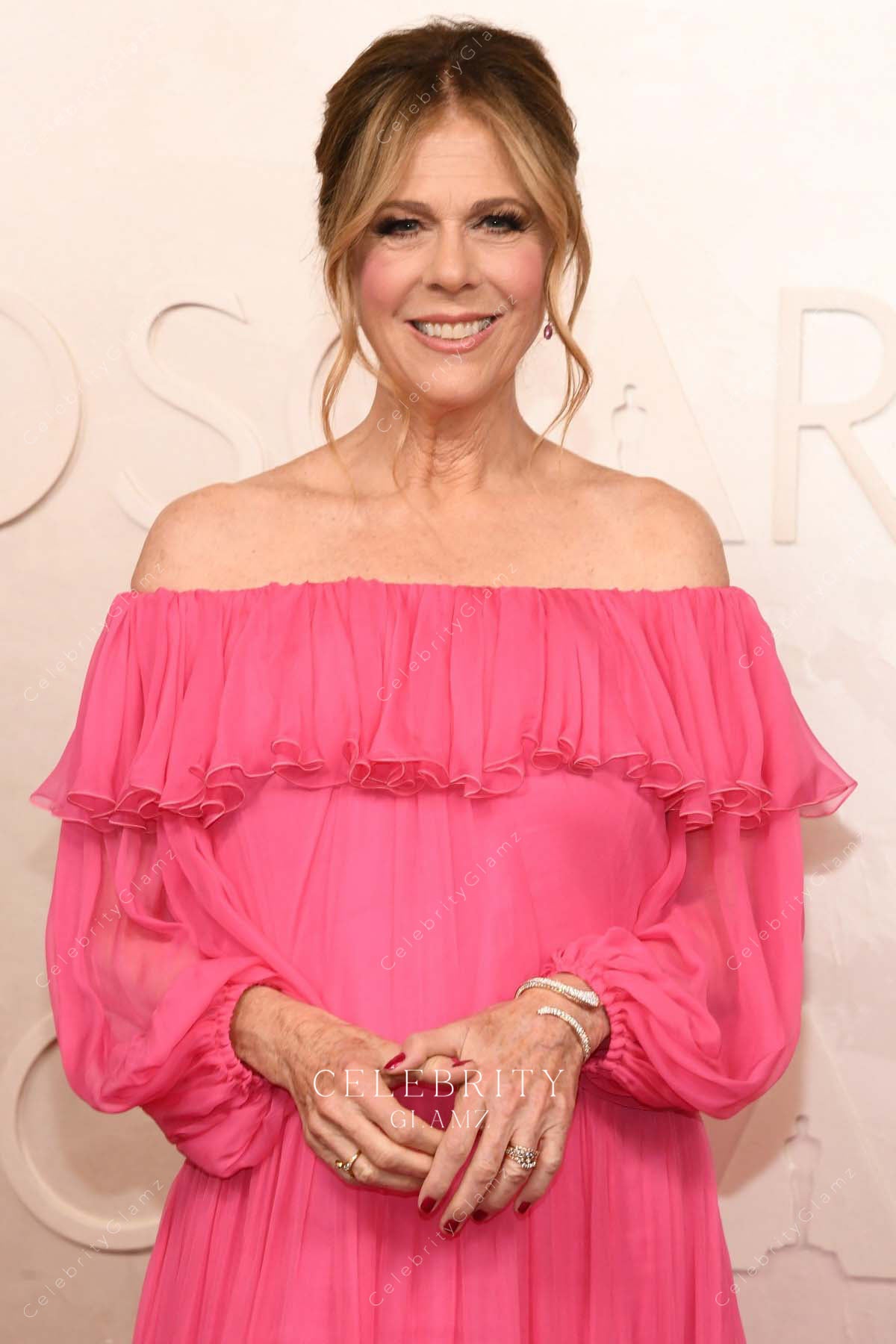 Rita Wilson 2025 Oscars red carpet ruffled neckline dress 