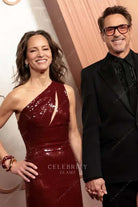 Susan Downey burgundy one shoulder 2025 Oscars red carpet dress